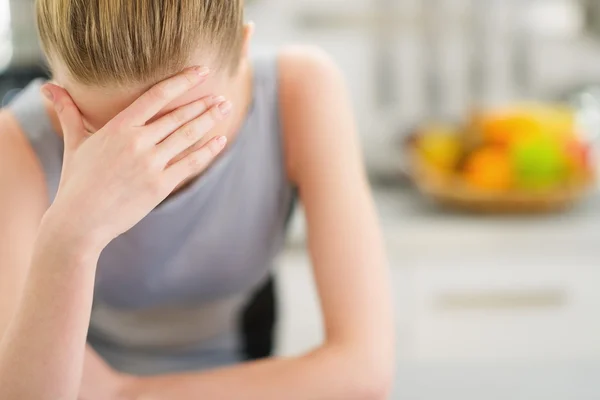 Portrait of stressed young housewife in modern kitchen